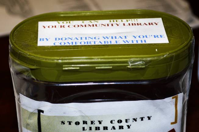 A donation jar sits on a desk at the children's book nook inside a community center in Virginia City. Community Chest, a nonprofit group, opened the book nook in 2013, about a year after the Storey County Public Library closed.
